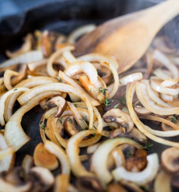 Onions and mushrooms caramelizing in pan for cheesesteak