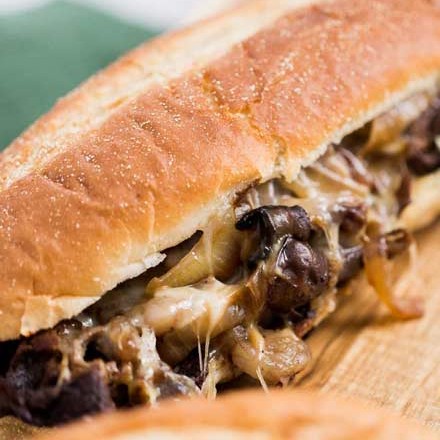 Juicy ribeye steak, caramelized onions and mushrooms, gooey provolone cheese and a mouthwatering horseradish sauce... it's the perfect All-American Cheesesteak! | #cheesesteak #phillycheesesteak #hoagie #sandwich