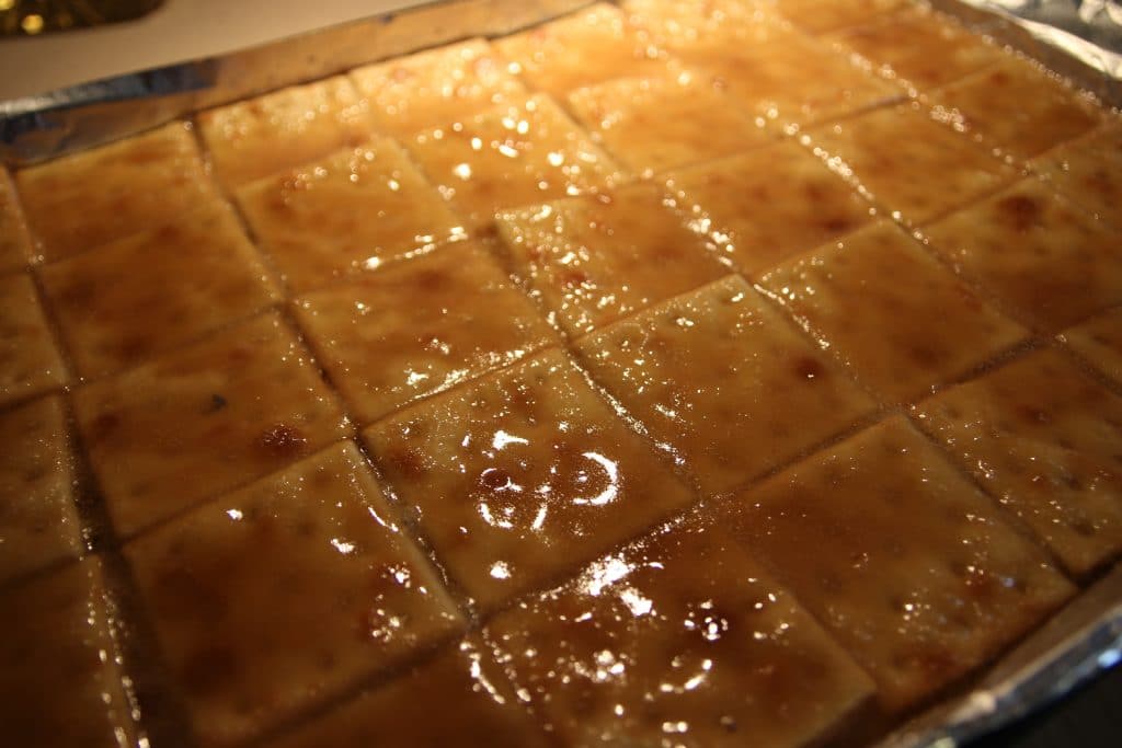 Saltine crackers are transformed into decadent white chocolate covered toffee studded with sweet cranberries and crunchy toasted almonds