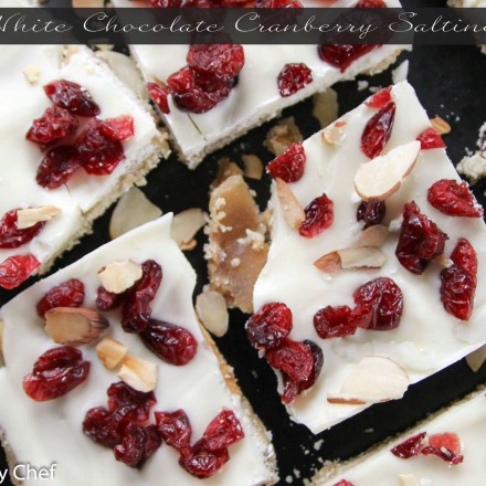 Saltine crackers are transformed into decadent white chocolate covered toffee studded with sweet cranberries and crunchy toasted almonds