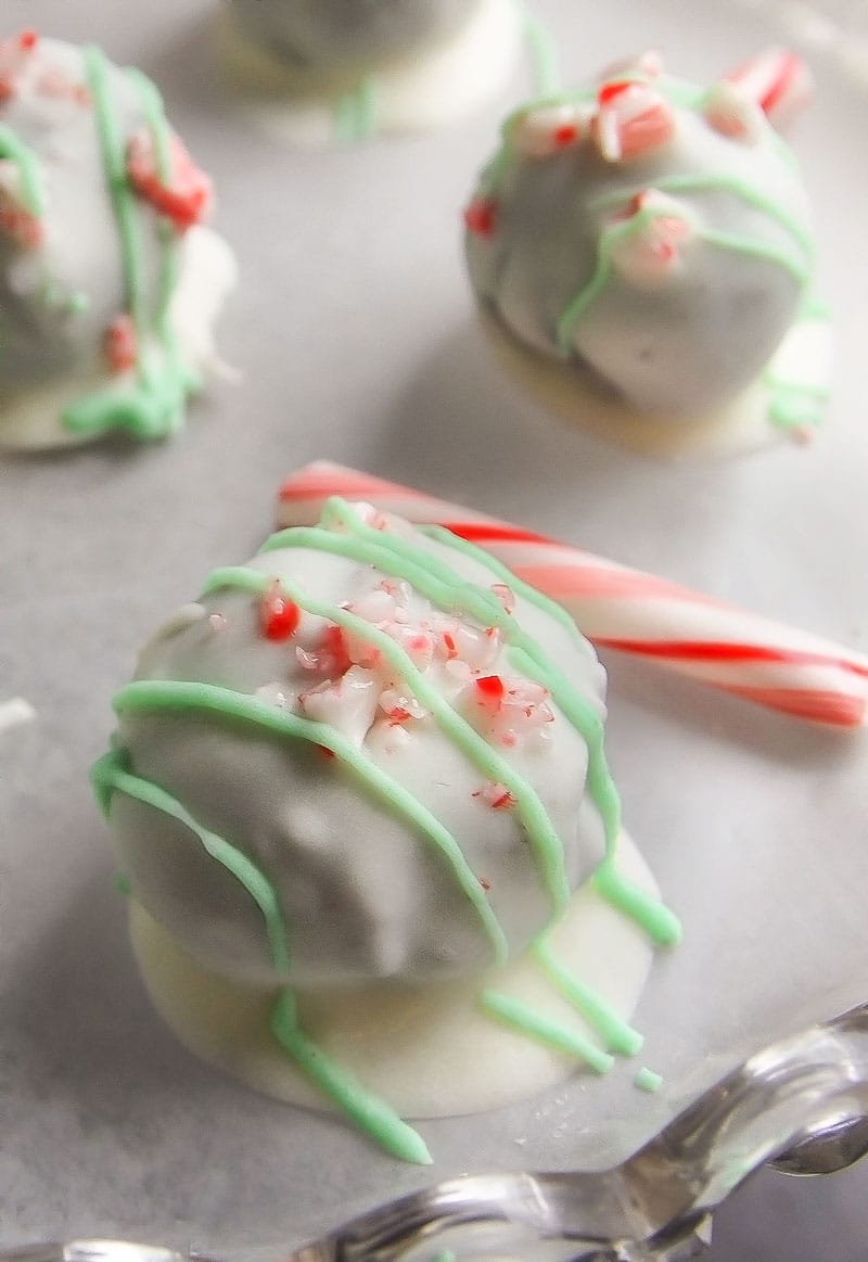 Peppermint Oreo Truffles | Creamy Oreo truffles, flavored with peppermint, coated in rich white chocolate and topped with crushed candy canes.. soon to be your favorite holiday treat!