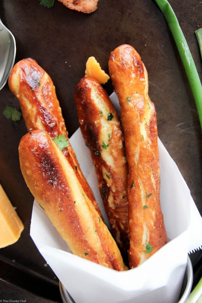 Baked Soft Pretzel Sticks - Soft, tender, buttery and brushed with a garlic and herb butter... these soft pretzel sticks from scratch taste amazingly good!