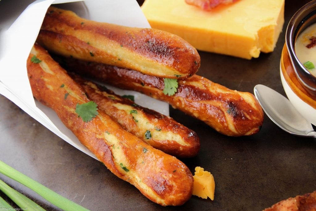 Baked Soft Pretzel Sticks - Soft, tender, buttery and brushed with a garlic and herb butter... these soft pretzel sticks from scratch taste amazingly good!