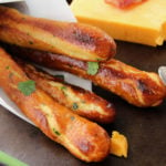 Baked Soft Pretzel Sticks - Soft, tender, buttery and brushed with a garlic and herb butter... these soft pretzel sticks from scratch taste amazingly good!