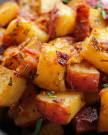 Perfectly seasoned and roasted red-skin potatoes topped with caramelized onions, crispy bacon and fresh herbs. The perfect side dish for breakfast!