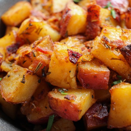 Perfectly seasoned and roasted red-skin potatoes topped with caramelized onions, crispy bacon and fresh herbs. The perfect side dish for breakfast!