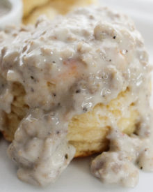Soft and fluffy buttermilk biscuits, perfectly big yet light at the same time, smothered with a creamy homemade sausage gravy... classic down home cooking!