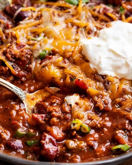 Rich hearty chili, made with beef or turkey!  Since it's made in the Instant Pot, it tastes like it simmered for hours - yet it's ready in 40 minutes! #instantpot #pressurecooker #chili #chilirecipe #beef #turkey #comfortfood #dinner #easyrecipe #beans