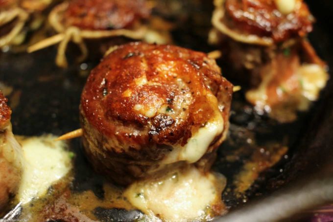 Stuffed flank steak pinwheels in cast iron pan