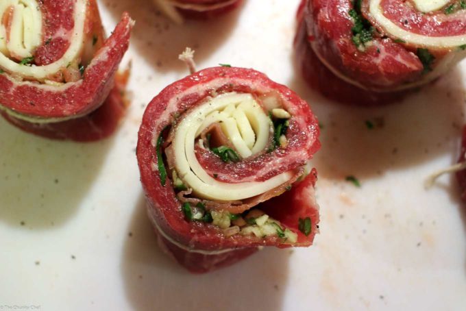 Steak medallions rolled up on cutting board