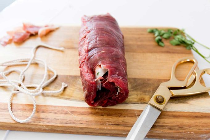 Italian flank steak rolled up in log