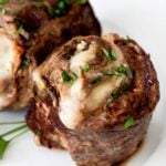 Impress anyone with this easy flank steak that's rolled with garlic, herbs, prosciutto ham and provolone cheese.  Perfect on the stove/oven, or on the grill, these are the ultimate Italian steak pinwheels! #steak #flanksteak #stuffed #pinwheels #grilled #baked #Italian #steakpinwheels #steakmedallions