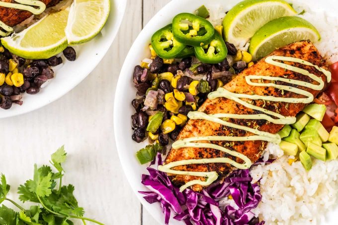 two white bowls filled with blackened fish tacos