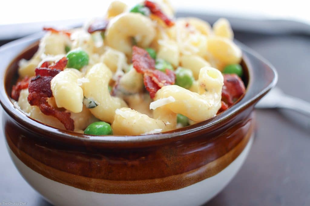 Rich and creamy macaroni and cheese gets lightened up a bit and tossed with sweet peas, crispy bacon and flavorful caramelized onions!