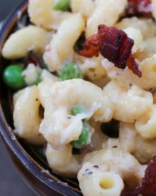 Rich and creamy macaroni and cheese gets lightened up a bit and tossed with sweet peas, crispy bacon and flavorful caramelized onions!