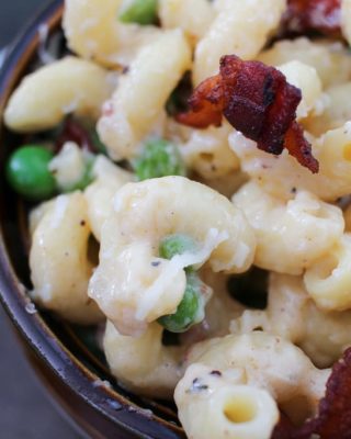 Rich and creamy macaroni and cheese gets lightened up a bit and tossed with sweet peas, crispy bacon and flavorful caramelized onions!