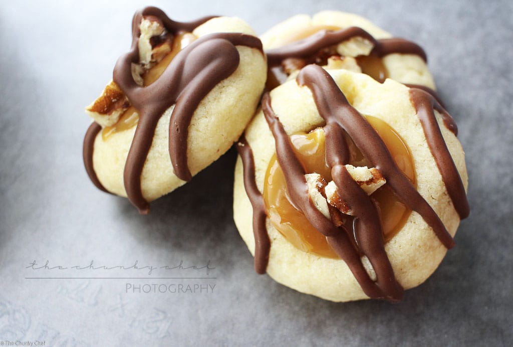 Turtle Twix Thumbprint Cookies | The Chunky Chef | Thumbprint cookies are such a classic... this spin on them includes a gooey caramel center and drizzled melted chocolate. Tastes just like a Twix!