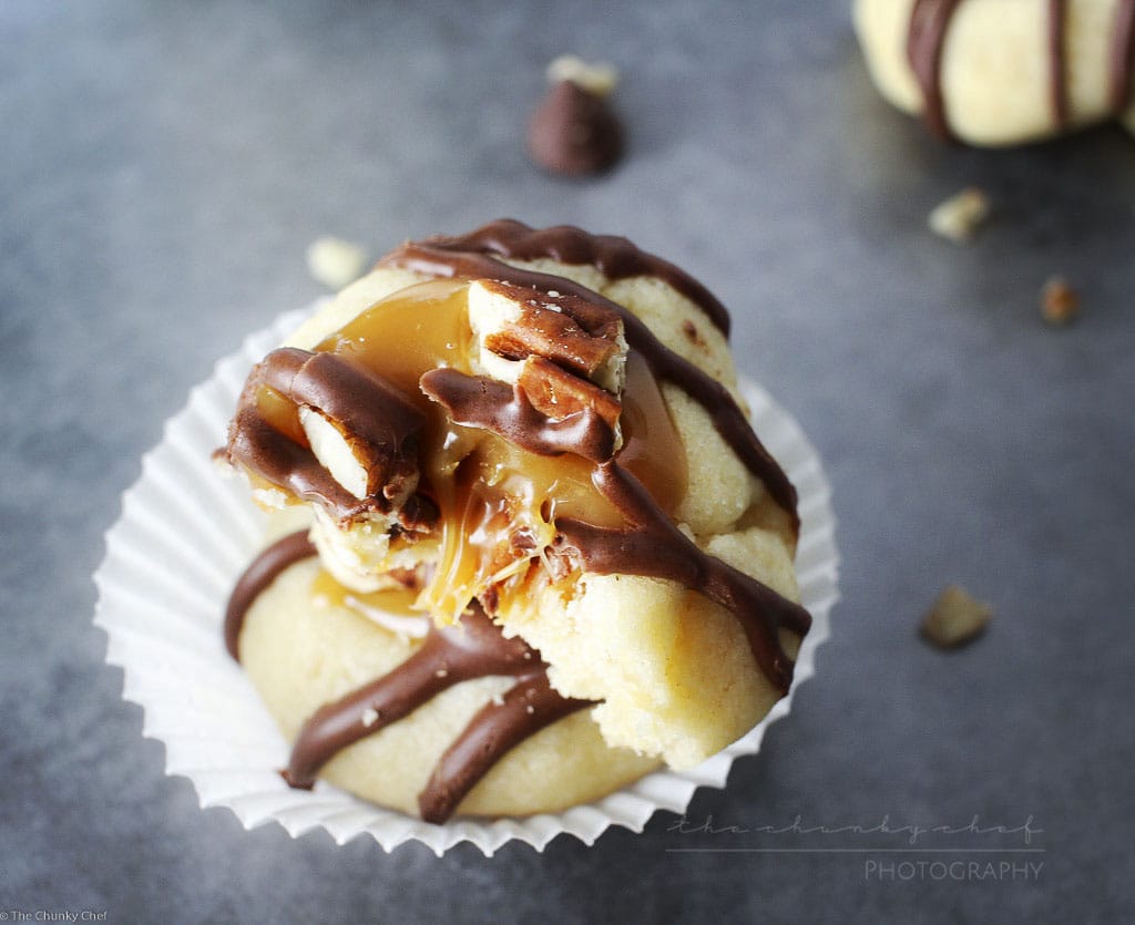 Turtle Twix Thumbprint Cookies | The Chunky Chef | Thumbprint cookies are such a classic... this spin on them includes a gooey caramel center and drizzled melted chocolate. Tastes just like a Twix!