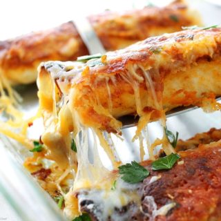 These beef enchiladas are filled with a flavorful beef, bean and chili mixture, covered in a delicious homemade sauce and smothered in gooey cheese!