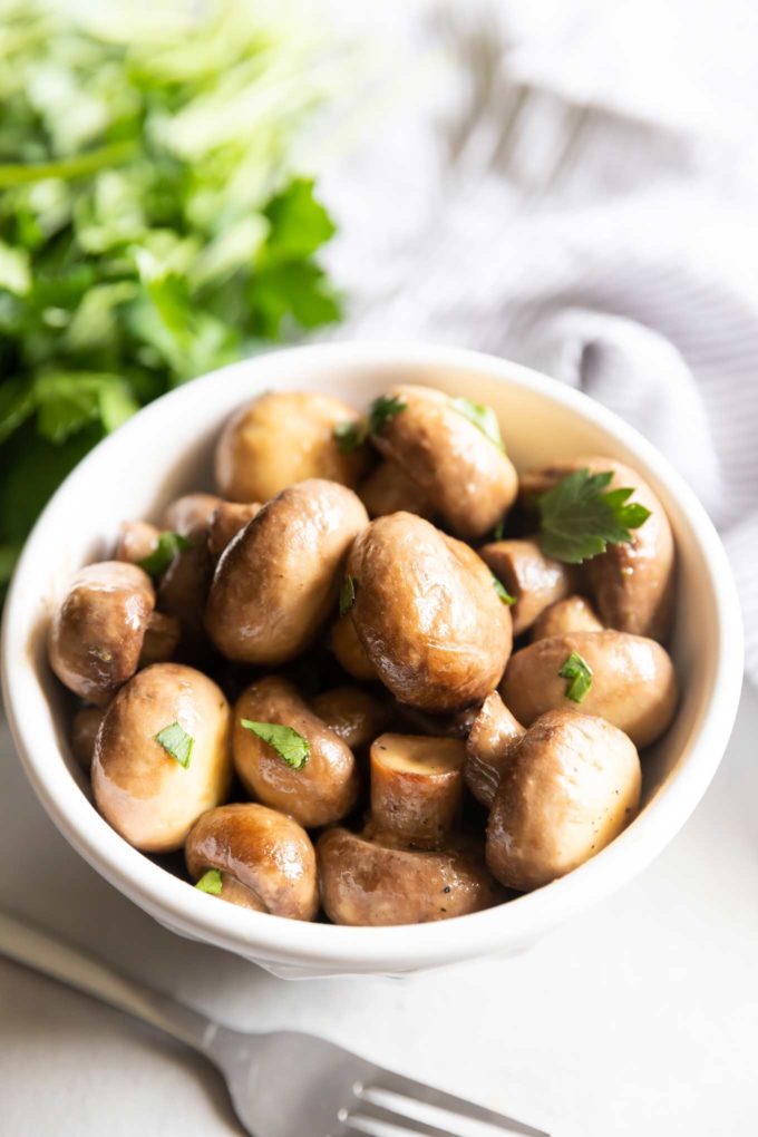 Crockpot mushrooms in white bowl