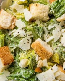 Perfect restaurant-style Caesar salad with homemade dressing and homemade garlic croutons. Amazing as a side salad, or add some grilled chicken and make it a meal! #salad #dressing #saladdressing #caesar #homemade #croutons #fromscratch
