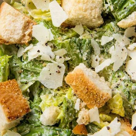 Perfect restaurant-style Caesar salad with homemade dressing and homemade garlic croutons.  Amazing as a side salad, or add some grilled chicken and make it a meal! #salad #dressing #saladdressing #caesar #homemade #croutons #fromscratch