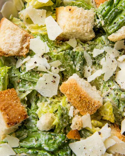 Perfect restaurant-style Caesar salad with homemade dressing and homemade garlic croutons.  Amazing as a side salad, or add some grilled chicken and make it a meal! #salad #dressing #saladdressing #caesar #homemade #croutons #fromscratch