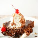 Deliciously fudgy brownies made with Coca-Cola, topped with a generous scoop of vanilla bean ice cream, and drizzled with a coca cola chocolate sauce!