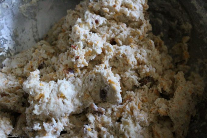 Fluffy buttermilk biscuits that are both savory and sweet... flavored with cheddar cheese, crispy bacon and maple syrup, then brushed with melted butter!