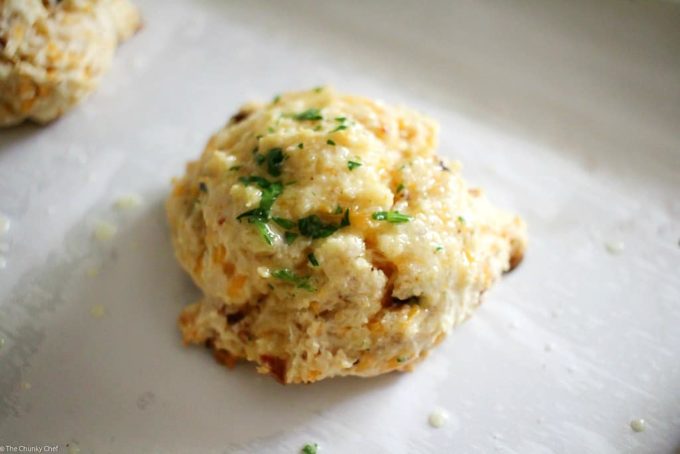 Fluffy buttermilk biscuits that are both savory and sweet... flavored with cheddar cheese, crispy bacon and maple syrup, then brushed with melted butter!