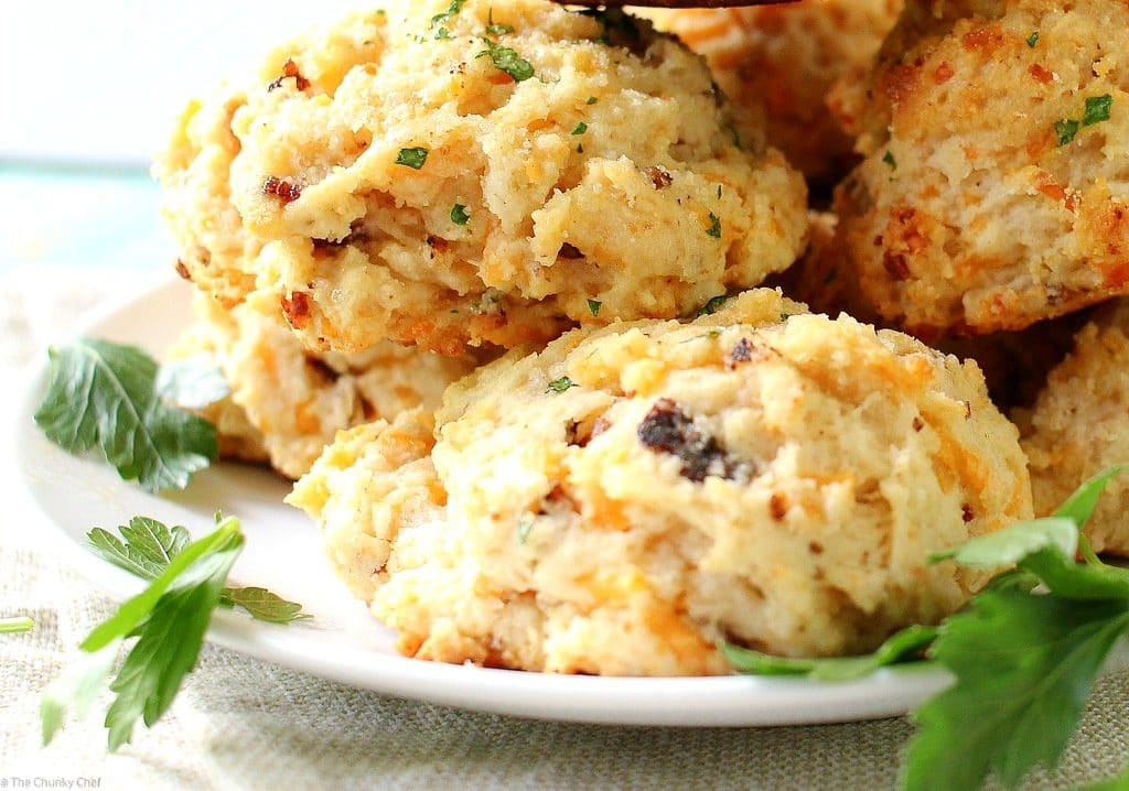 Fluffy buttermilk biscuits that are both savory and sweet... flavored with cheddar cheese, crispy bacon and maple syrup, then brushed with melted butter!