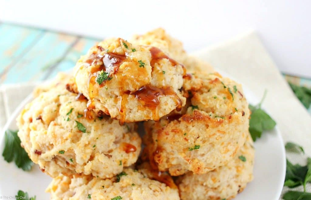 Fluffy buttermilk biscuits that are both savory and sweet... flavored with cheddar cheese, crispy bacon and maple syrup, then brushed with melted butter!