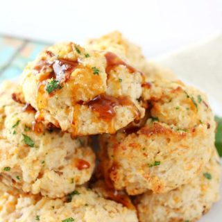 Fluffy buttermilk biscuits that are both savory and sweet... flavored with cheddar cheese, crispy bacon and maple syrup, then brushed with melted butter!