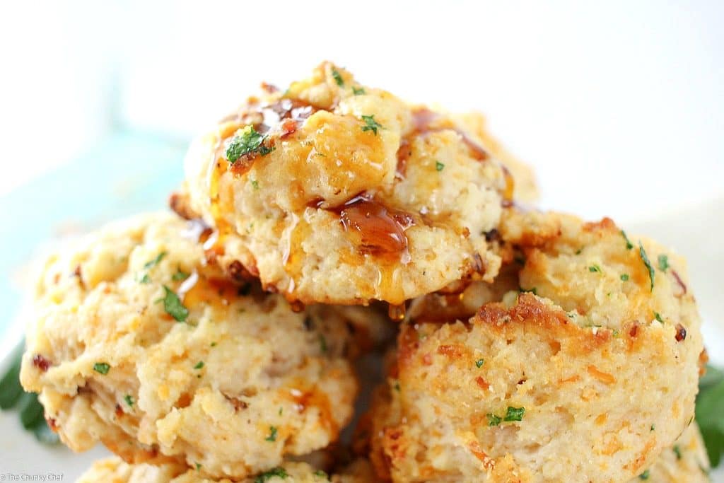 Fluffy buttermilk biscuits that are both savory and sweet... flavored with cheddar cheese, crispy bacon and maple syrup, then brushed with melted butter!