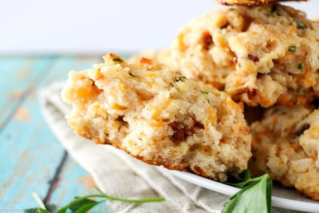 Fluffy buttermilk biscuits that are both savory and sweet... flavored with cheddar cheese, crispy bacon and maple syrup, then brushed with melted butter!