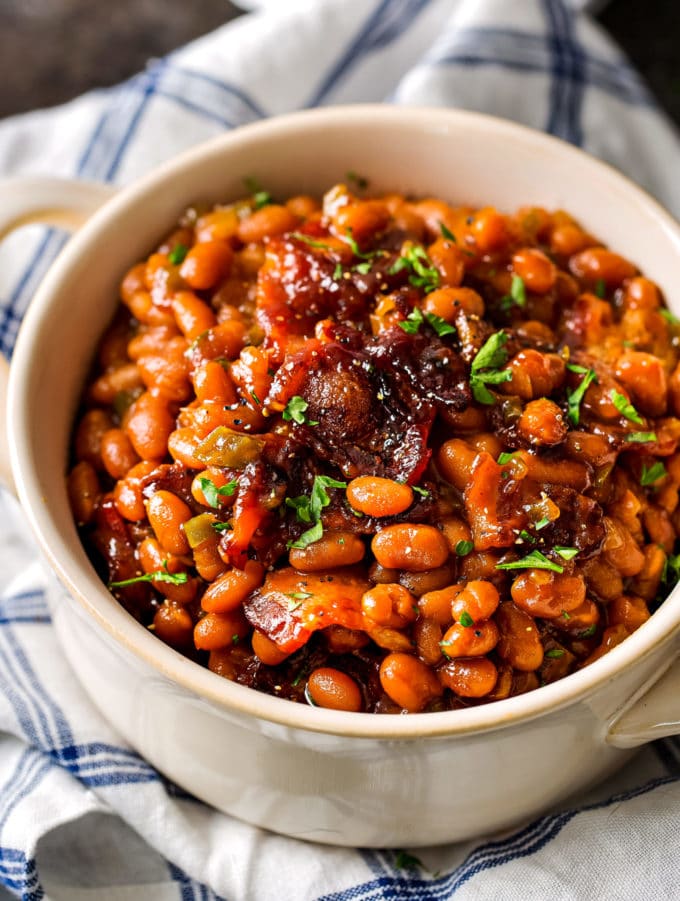 These Brown Sugar and Bacon Baked Beans are the perfect blend of sweet, savory and smoky! Topped with delicious bacon, they're always a hit, and are SO easy to make! #bakedbeans #beans #baked #bacon #brownsugar #potluck #bbq #summer #cookout #easyrecipe