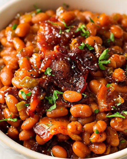 These Brown Sugar and Bacon Baked Beans are the perfect blend of sweet, savory and smoky! Topped with delicious bacon, they're always a hit, and are SO easy to make! #bakedbeans #beans #baked #bacon #brownsugar #potluck #bbq #summer #cookout #easyrecipe