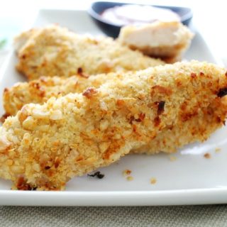 Not your run of the mill baked chicken tenders... this chicken is crusted in a delicious coconut and cashew breading and baked to golden brown perfection!