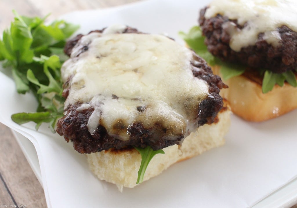 Caramelized Onion Beef Sliders | The Chunky Chef | Ground beef sliders smothered in melted gruyere cheese, topped with caramelized onions and thyme, peppered bacon and a flavorful A1 mayo!