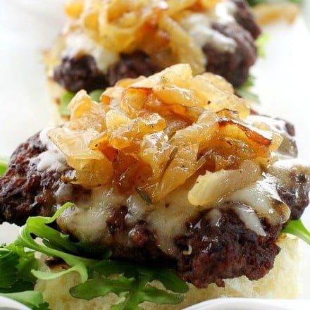 Caramelized Onion Beef Sliders | The Chunky Chef | Ground beef sliders smothered in melted gruyere cheese, topped with caramelized onions and thyme, peppered bacon and a flavorful A1 mayo!