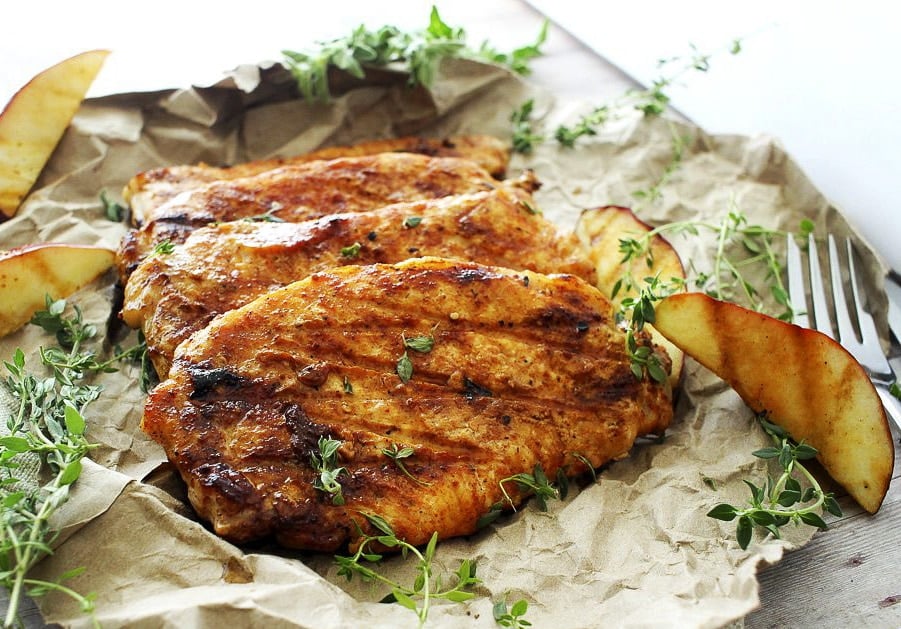 Apple Cider Orange and Thyme Grilled Pork Chops | The Chunky Chef | Summer meets Fall in these apple cider orange and thyme grilled pork chops.. deliciously juicy and tender with a finger-licking glaze! A "must try" recipe!