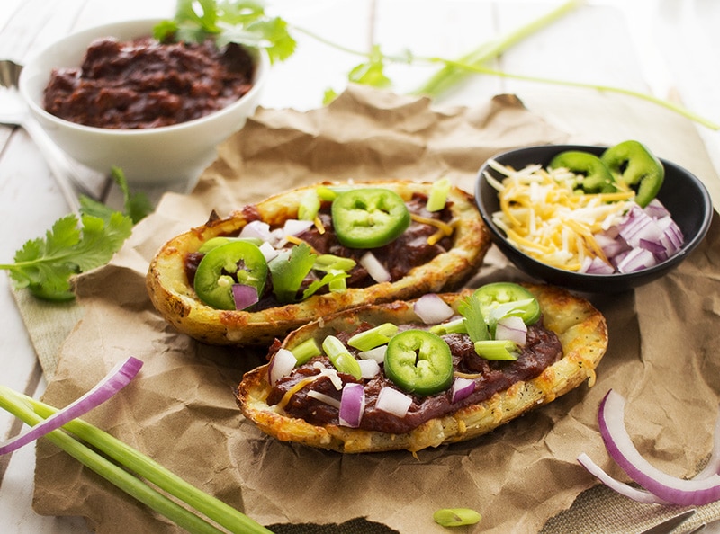 Loaded Beef BBQ Potato Skins | The Chunky Chef | The classic potato skins appetizer gets a BBQ twist! Savory beef BBQ on top of crispy and cheesy potato skins - perfect for game day or a great snack!