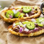 Loaded Beef BBQ Potato Skins | The Chunky Chef | The classic potato skins appetizer gets a BBQ twist! Chipotle beef BBQ on top of crispy and cheesy potato skins - perfect for game day or a great snack!