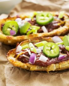 Loaded Beef BBQ Potato Skins | The Chunky Chef | The classic potato skins appetizer gets a BBQ twist! Chipotle beef BBQ on top of crispy and cheesy potato skins - perfect for game day or a great snack!