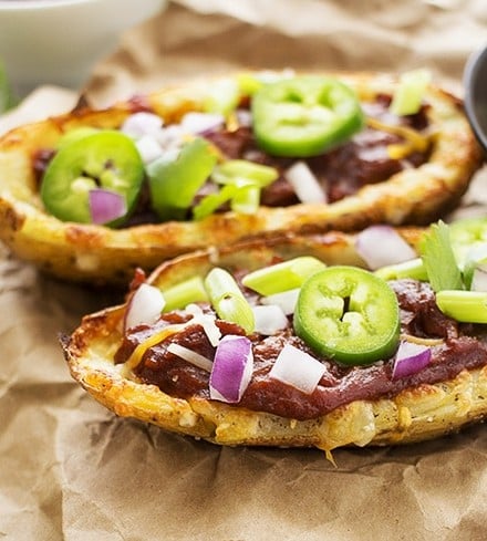 Loaded Beef BBQ Potato Skins | The Chunky Chef | The classic potato skins appetizer gets a BBQ twist! Chipotle beef BBQ on top of crispy and cheesy potato skins - perfect for game day or a great snack!