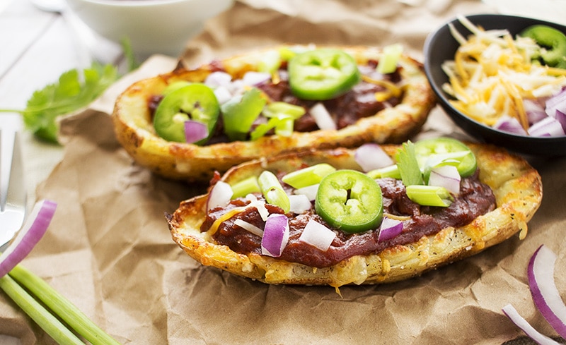 Loaded Beef BBQ Potato Skins | The Chunky Chef | The classic potato skins appetizer gets a BBQ twist! Chipotle beef BBQ on top of crispy and cheesy potato skins - perfect for game day or a great snack!