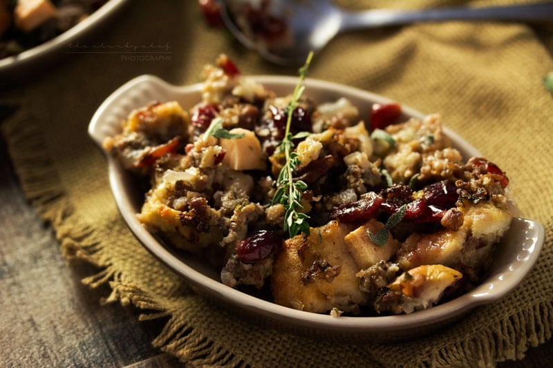 Harvest Apple Cranberry and Sage Sausage Stuffing | The ultimate sausage stuffing recipe for Thanksgiving! All your favorite Fall flavors are baked together in a perfectly textured side dish you'll love!