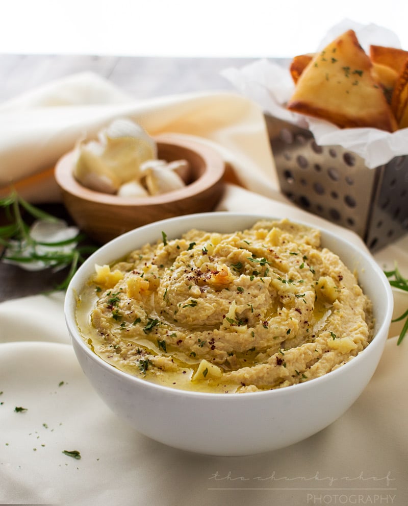 Roasted Garlic Hummus | The Chunky Chef | Creamy, rich hummus with a deep, slightly sweet roasted garlic flavor. Whip it up in the food processor and enjoy it with some crispy pita chips or naan!