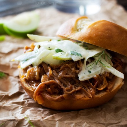 Apple Bourbon Pulled Pork Sandwiches | The Chunky Chef | Soft pretzel buns filled with tender, juicy apple bourbon pulled pork and topped with a refreshing apple fennel slaw. The King of pulled pork sandwiches!
