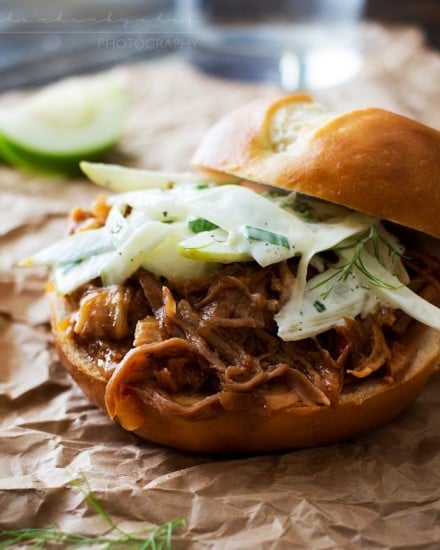 Apple Bourbon Pulled Pork Sandwiches | The Chunky Chef | Soft pretzel buns filled with tender, juicy apple bourbon pulled pork and topped with a refreshing apple fennel slaw. The King of pulled pork sandwiches!